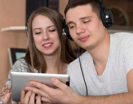 Young couple with electronic device Stock Photos