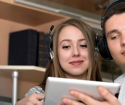 Young couple with electronic device Stock Photos