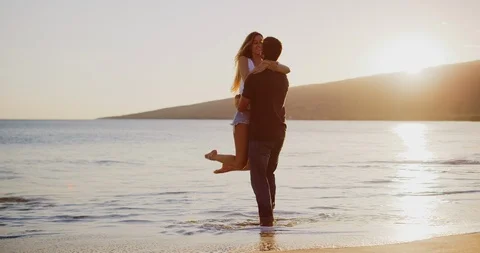 Young couple embracing on the beach Stock Footage 106513506