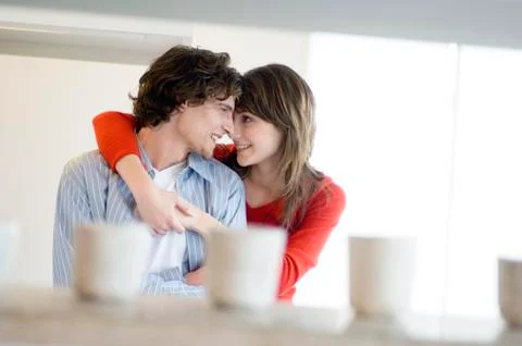 Young couple embracing, looking at each other Stock Photos