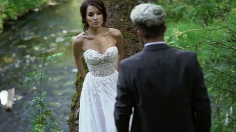 Young couple embracing near waterfall Stock Footage