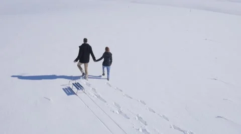 Young couple enjoy on the snow Stockbeeldmateriaal 58744317