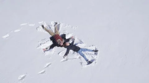 Young couple enjoy on the snow Видео 58744368