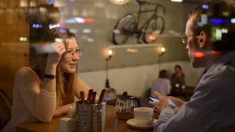Young couple enjoying drinks in a date in an outdoor bar esplanade by night Stock-Footage 74213835