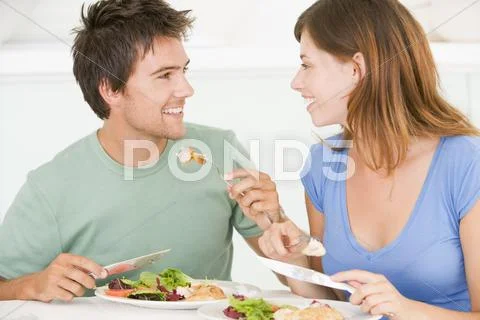 Young couple enjoying meal,mealtime together Stock Photos