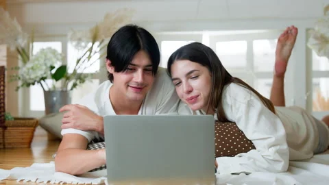 Young Couple Enjoying Quality Time with Technology at Home, Using Computer .. Stock Footage 252279477