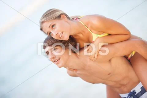 Young couple enjoying themselves at the beach Stock Photos