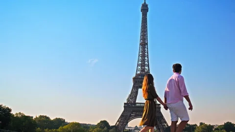 A young couple enjoys the view of Paris pointing at the Tower. Stock Footage 245455933
