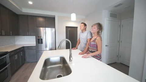 Young couple entering empty kitchen room of apartment condo for rent or sale Stock Footage 166664751