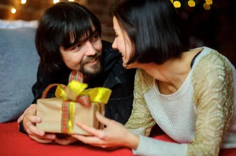 The young couple exchanges gifts. Stock Photos
