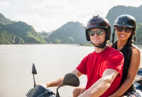 Young couple exploring Cat Ba Island on a motor scooter Stock Photos