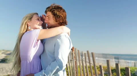 Young Couple Facing Each Other on Beach Stock Footage 21835915