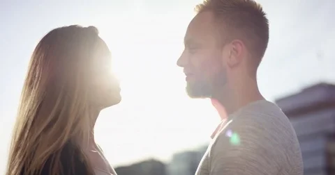Young couple is facing each other in beautiful backlit in a sunset in summer Stock Footage 78983998
