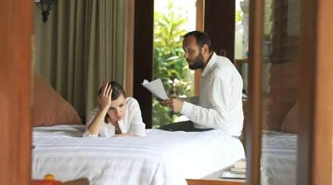 Young couple fighting, arguing over documents in bedroom at home Vídeo Stock 68185940
