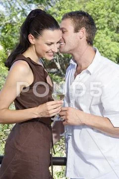 Young couple flirting, holding wine glasses, close-up Stock Photos