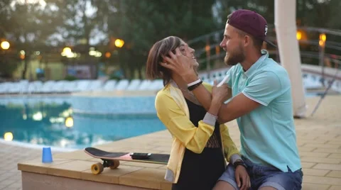Young couple fooling around by the pool Stock Footage 68538428