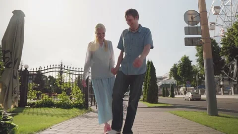 Young couple fooling around while walking in the city. Stock Footage 133312092