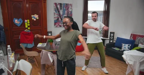 Young couple freelancers doing exercises at home during breaks from work Stock Footage 99322157