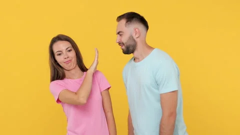 Young couple friends 20s in basic t-shirts posing isolated on yellow background Stock Footage 148322962