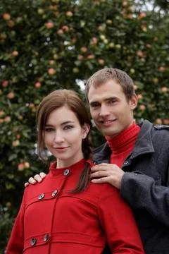 Young couple in front of apple tree Stock Photos