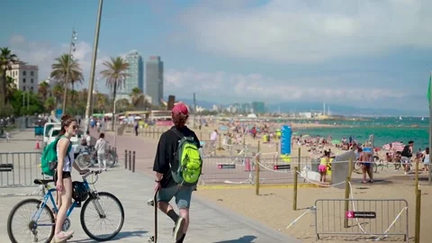 Young couple in front of Barcelona's beach promenade during COVID-19 pandemic. Stock Footage 133926662