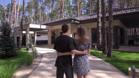 Young Couple in Front of the Modern House Hugging. Stock Footage 138896607
