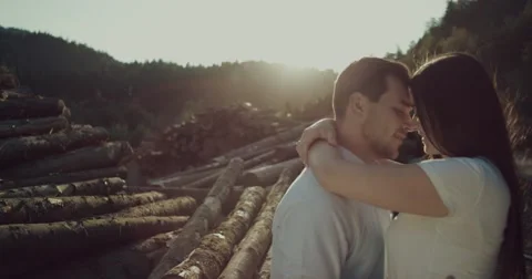 Young couple gently rubs noses in fores ,man kissing his girlfriend Stock Footage