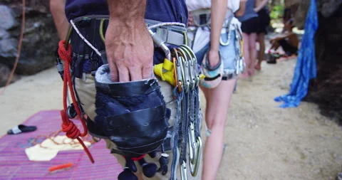 Young couple getting ready to climb, chalking hands, preparing to climb mountain Stock Footage 201095547