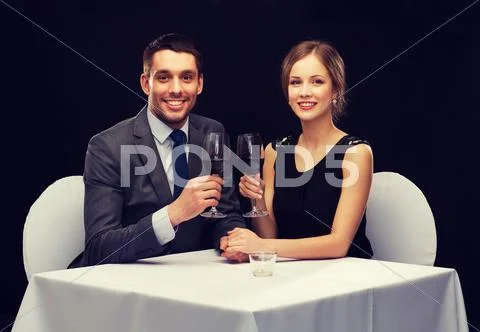 Young couple with glasses of wine at restaurant Stock Photos