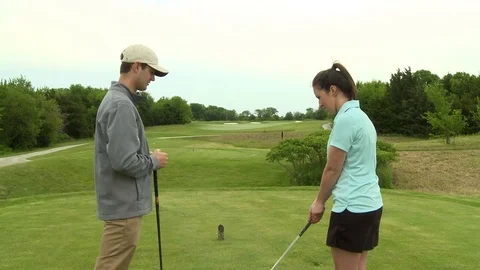Young couple on golf course Stock Footage 74254170