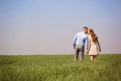 Young couple in green fields Stock Photos