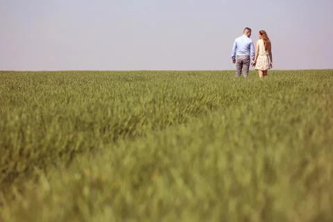 Young couple in green fields Stock Photos