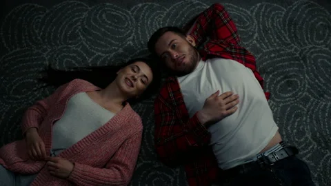 Young Couple Has Conversation Lying On Floor Stock Footage 150142467