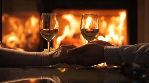 Young couple have romantic dinner with wine over fireplace background. 動画素材 80313066