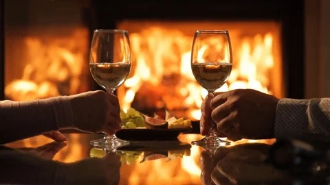 Young couple have romantic dinner with wine over fireplace background. Stock Footage 80313271