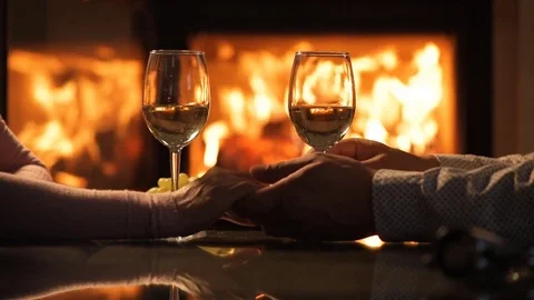 Young couple have romantic dinner with wine over fireplace background. Stock Footage 80313272