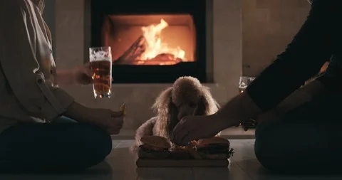 Young couple have romantic dinner with hamburgers and beer. Stock Footage 100413605