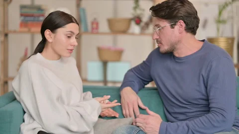 Young Couple having Argument While Sitting on Sofa at Home 스톡 동영상 147240752