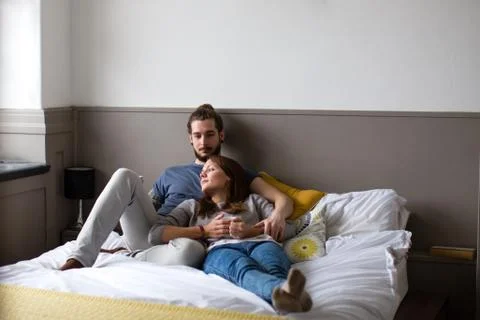 Young couple having coffee in bed Stock Photos