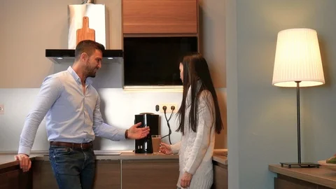 A young couple having a coffee together in the kitchen 스톡 동영상 86851489