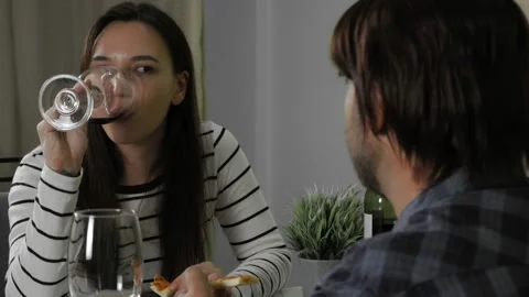 Young couple having date conversation at home with delivery pizza and red wine. Stock Footage 148607675