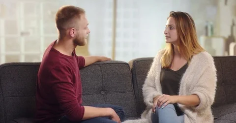 Young couple having differences on a couch Stock Footage 78030253