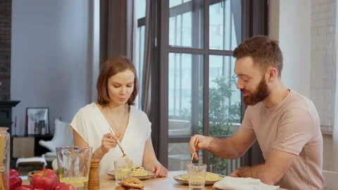 Young couple having dinner eating pasta at home Stock Footage 146277440