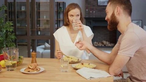 Young couple having dinner eating pasta at home Stock Footage 146278201