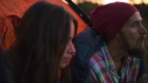 Young couple having dinner in the evening while sitting in a tent. Stock-Footage 116523773