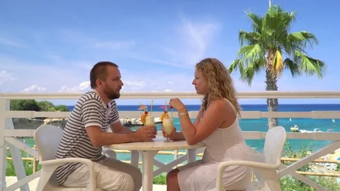 Young couple having drinks at the sea Stock Footage 71121256