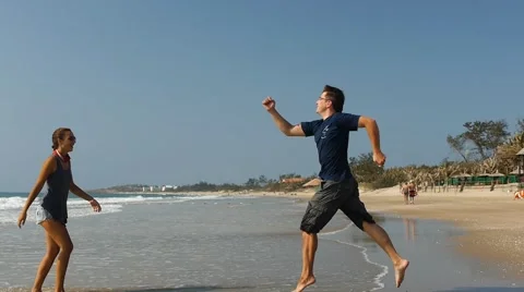 Young couple having fun and playing like kids on the beach. Slow motion Stock-Footage 50591238