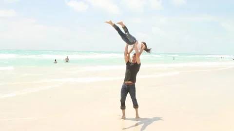Young couple having fun at the beach Stock Footage 7730789