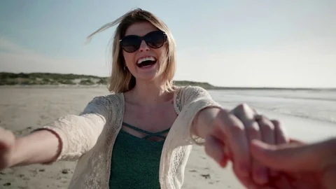Young couple having fun on beach Stock Footage 83359234