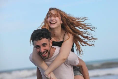 Young couple having fun at the beach Stock Photos